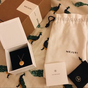 Mejuri zodiac necklace in cancer.